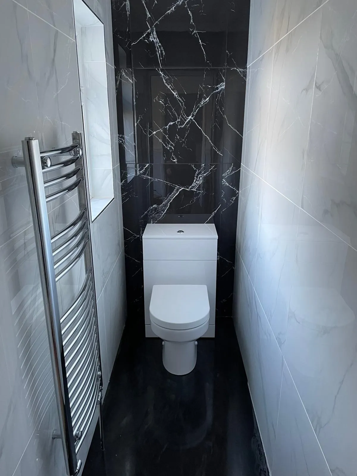 Fitted bathroom furniture run with patterned tiled floor