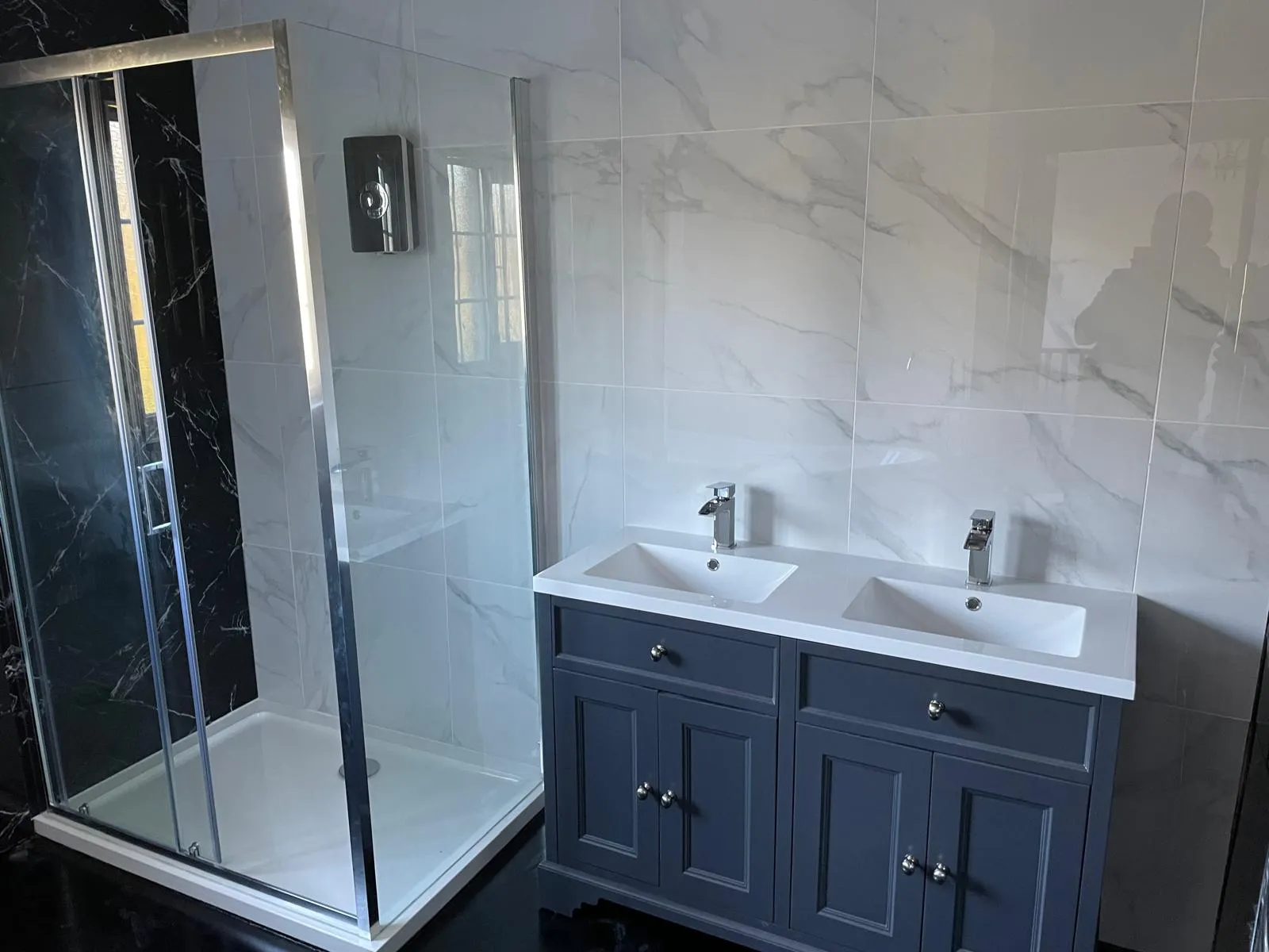 Compact cloakroom finished in white and black marble tiles