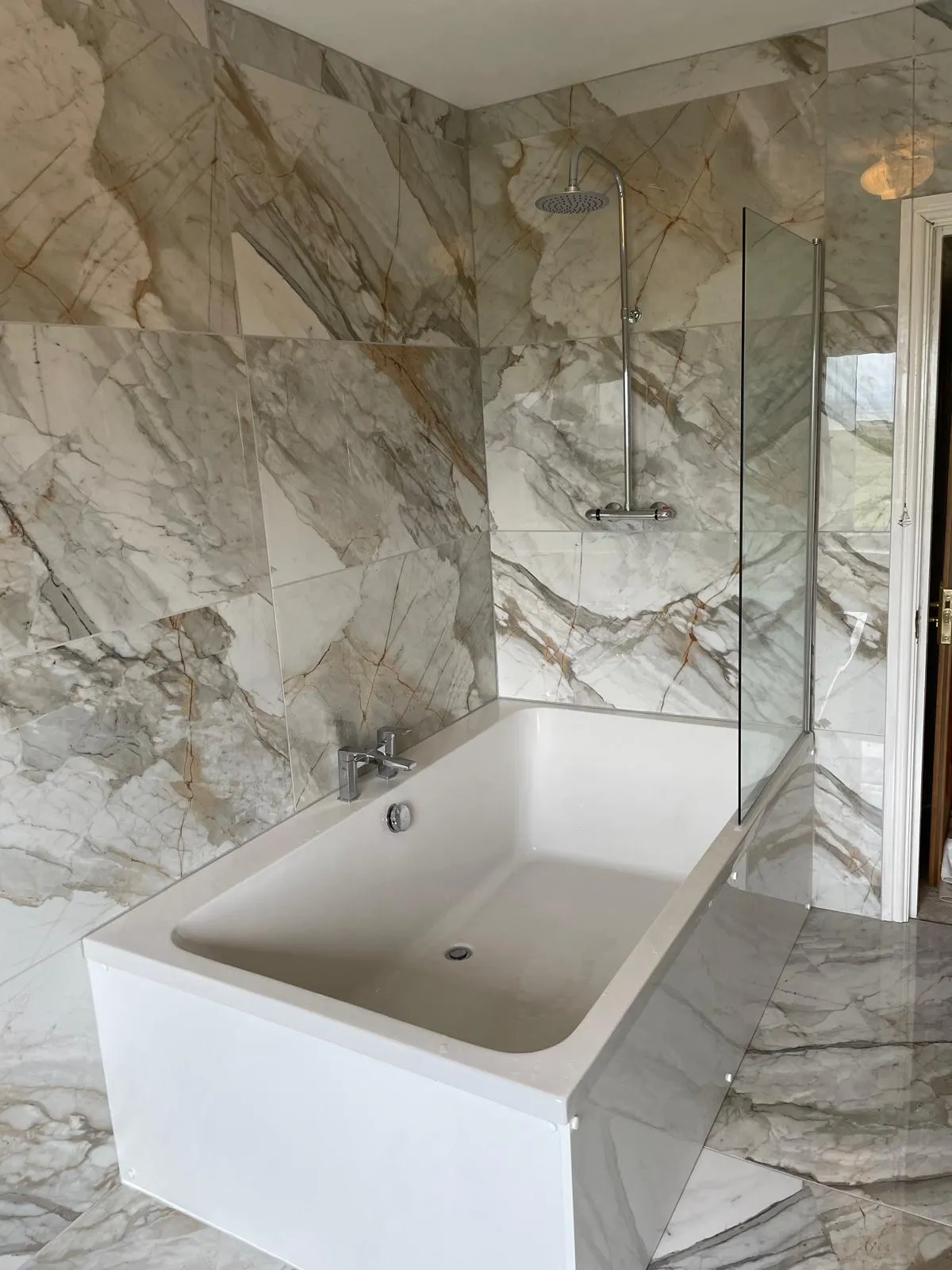 Quartzite tiled bathroom with bath and shower screen fitted near Tywyn