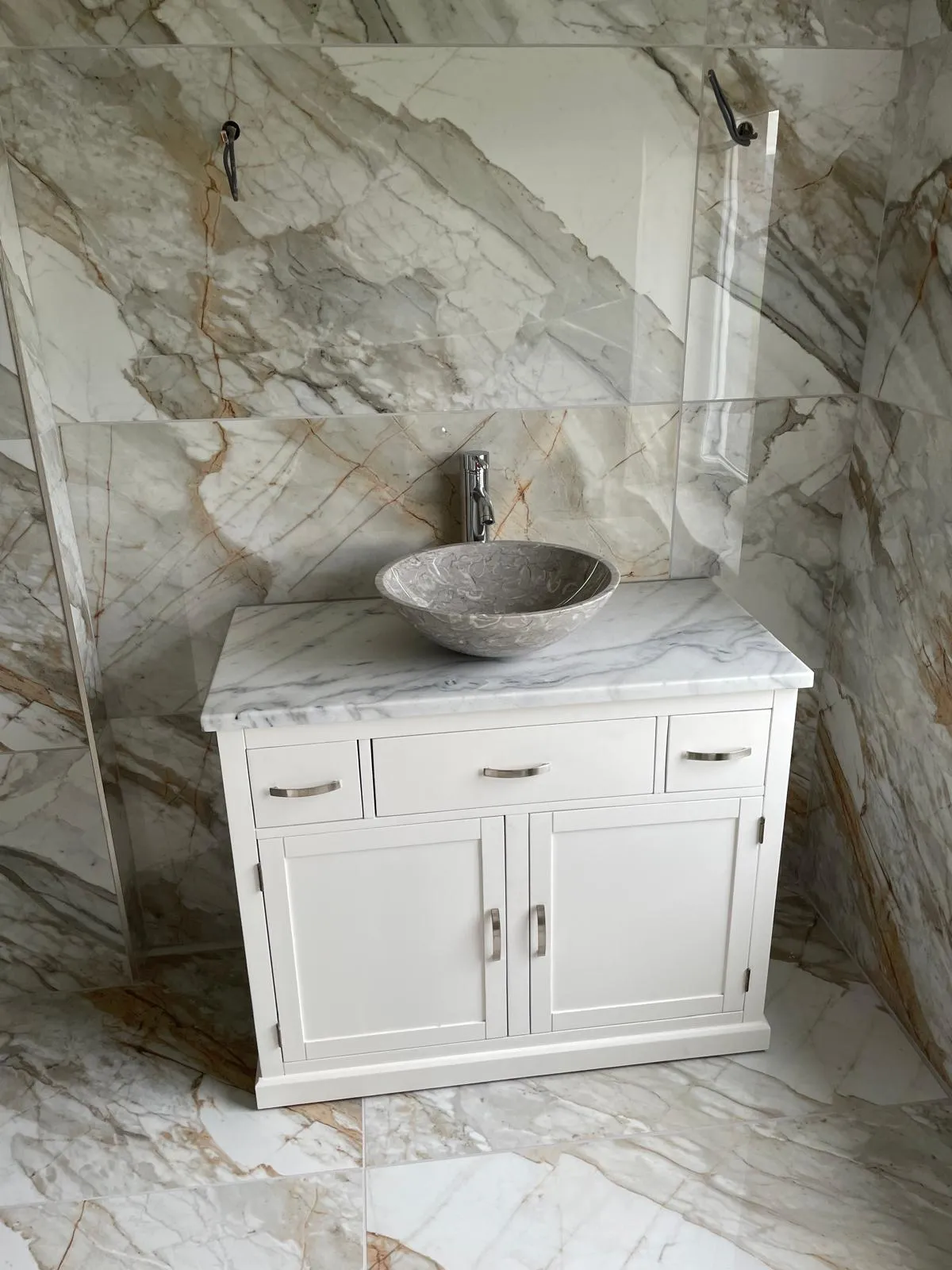 Marble topped vanity with stone vessel basin by CR Plumbing