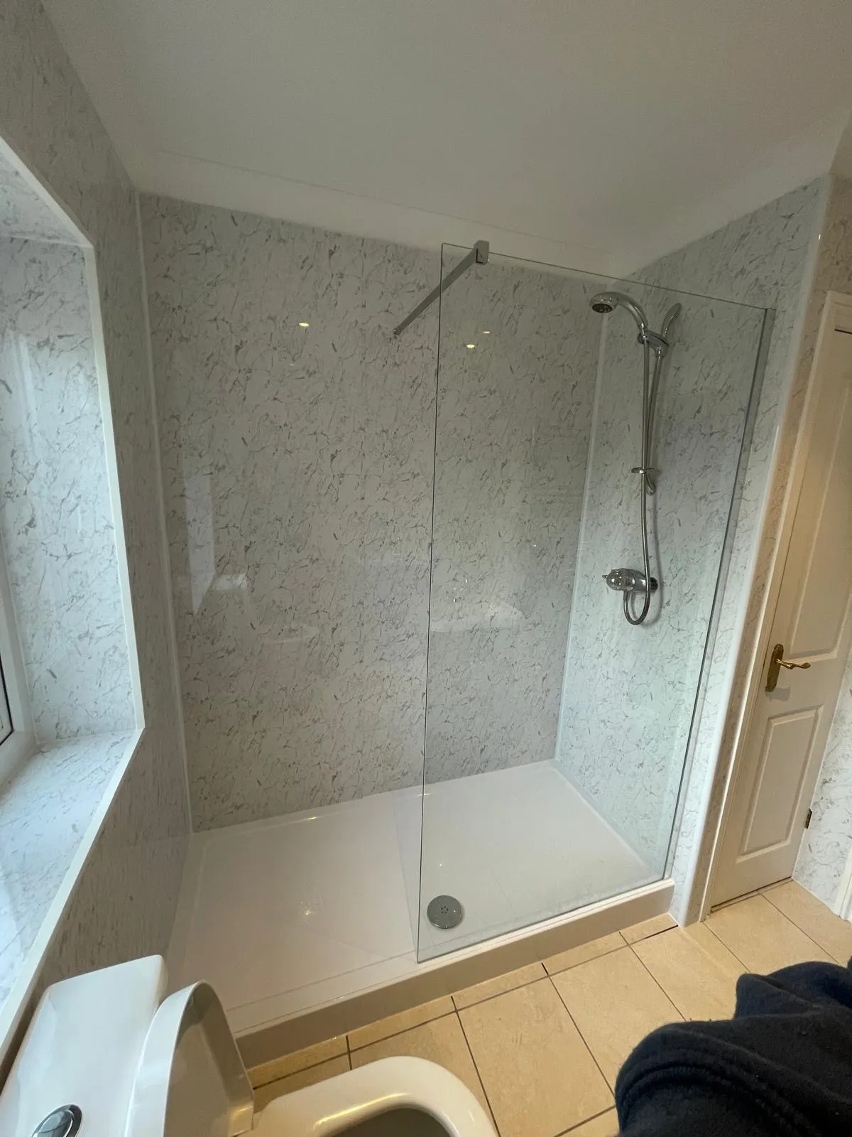 Marble bathroom with navy double vanity unit fitted by CR Plumbing in Tywyn